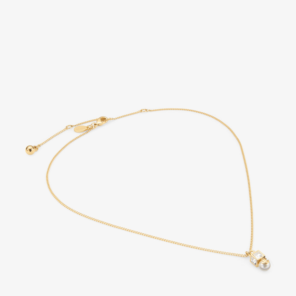 Colgante de metal dorado con perla y cristal
