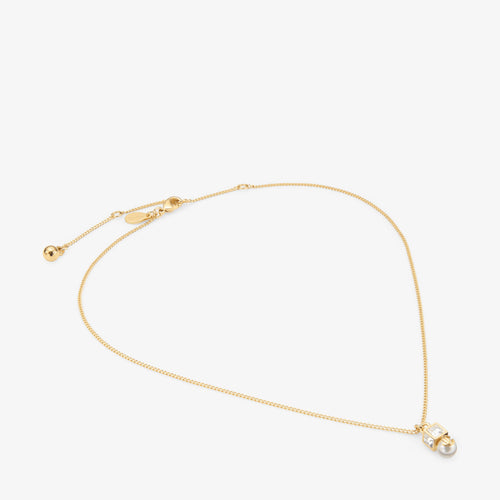 Colgante de metal dorado con perla y cristal