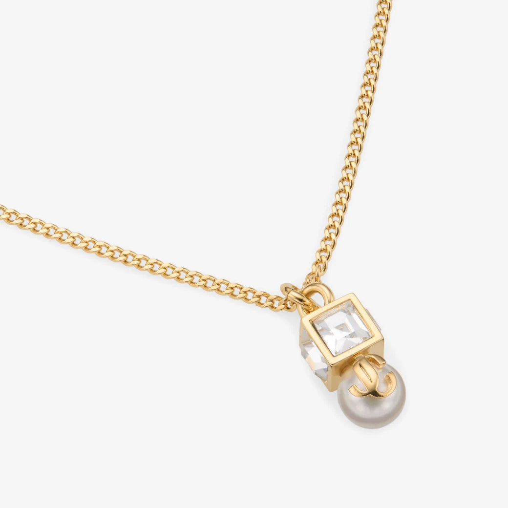 Colgante de metal dorado con perla y cristal